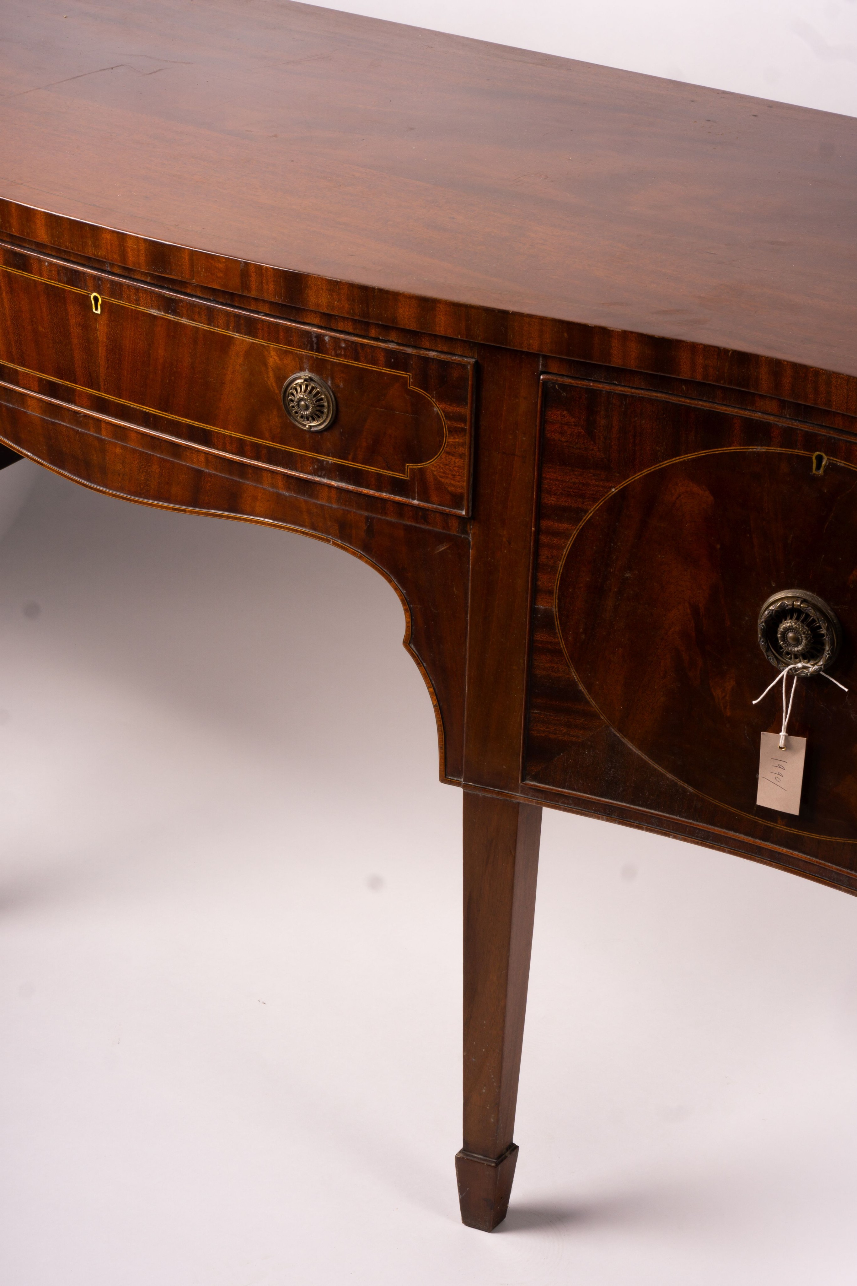 A George III style mahogany serpentine sideboard on square tapered legs, width 184cm, depth 63cm, height 93 cm